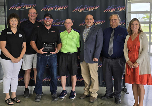 Dan Morrow receives his 2024 Distinguished Award for the Milford Campus. 