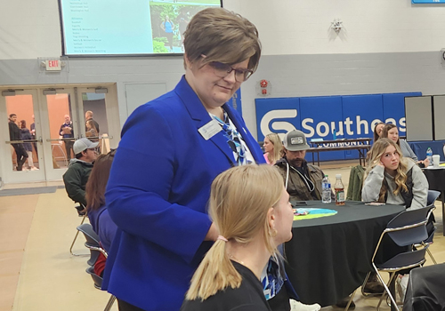 Kat Kreikemeier talks to a student at a Discovery Day. 