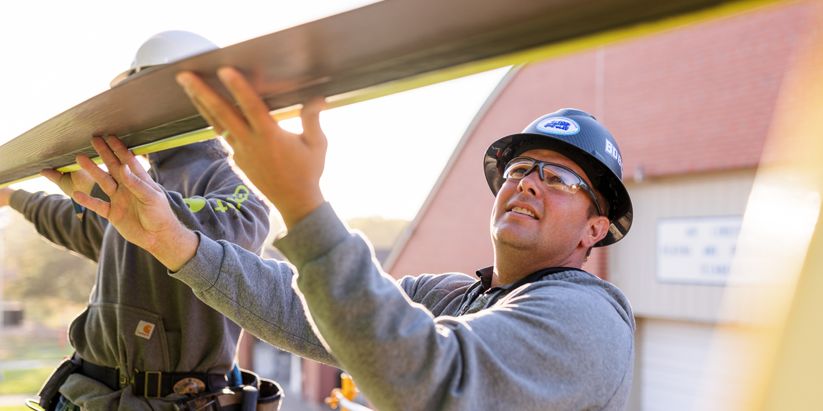 Construction students working on a house